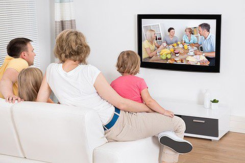 Young Family Watching TV Together